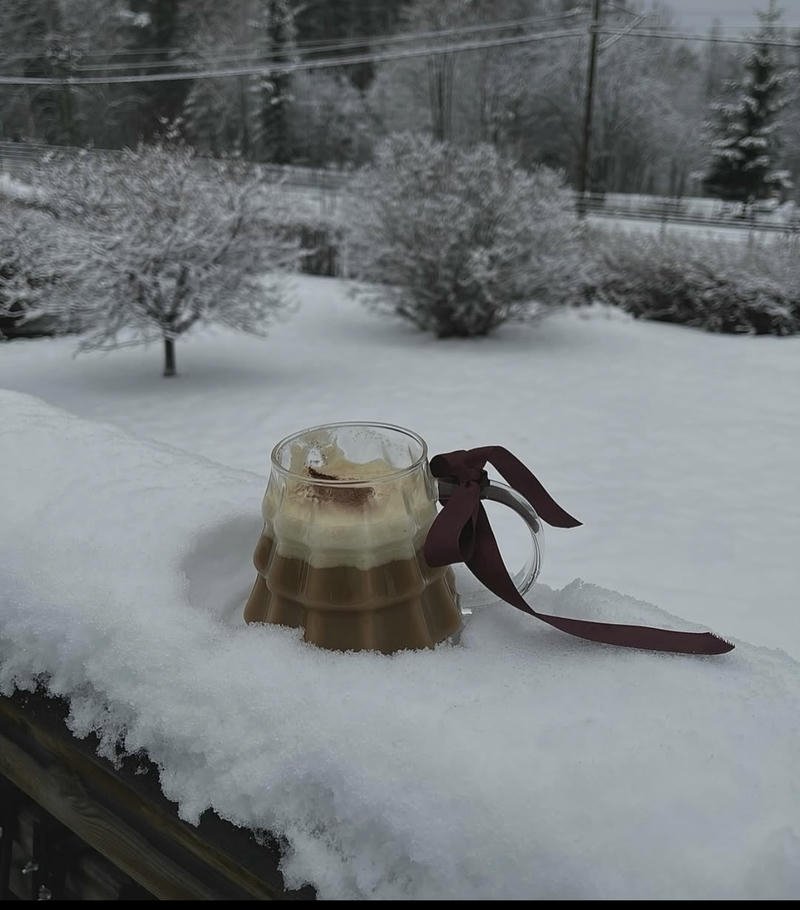 Warm winter coffee by snowy window creating cozy winter aesthetic pfp